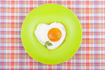 Scrambled in a heart shape on a plate.