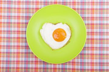 Scrambled in a heart shape on a plate.