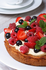 dessert berry tart decorated with strawberries, raspberries