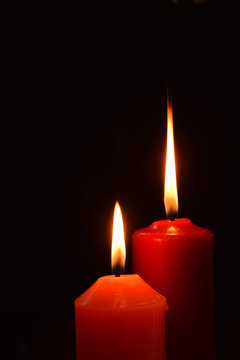 two candles on a black background