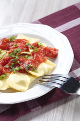 Portion of ravioli with tomato sauce