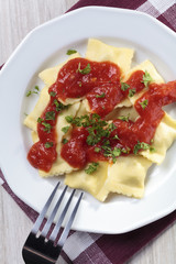 Portion of ravioli with tomato sauce