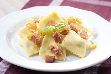 Portion of ravioli with onion and bacon