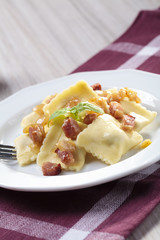 Portion of ravioli with onion and bacon