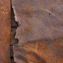 Old rusted metal surface texture with wood
