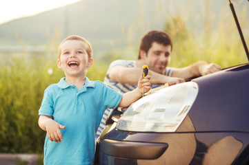 Father and son repairing car