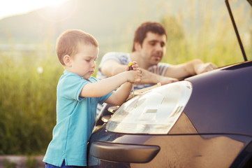 Father and son repairing car