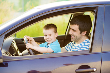Father and son driving car