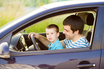 Father and son driving car