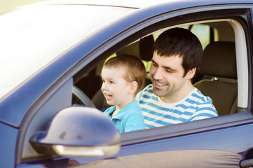 Father and son driving car