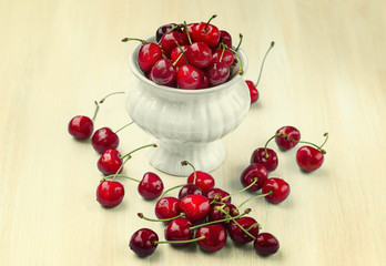 Ripe cherries on a wooden background  with retro filter effect