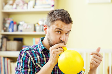 Father blowing balloon