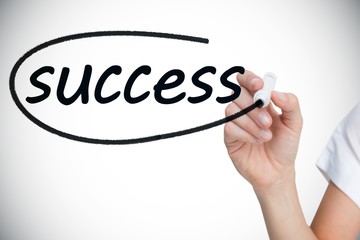 Businesswoman writing the word success