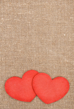 Felt red hearts on the burlap