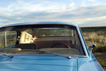 Blue car at the beach