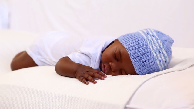 Baby boy sleeping in crib