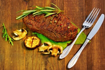 Grilled beef steaks with mushrooms
