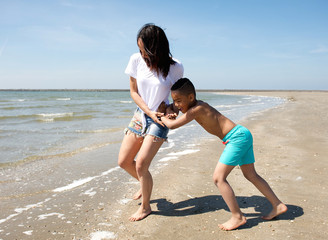 Mother and son playing at the beach