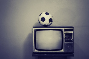 An old soccer ball on a retro TV, black and white