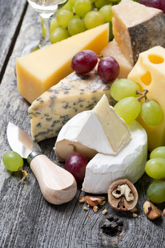 assortment of fresh cheeses, grapes and walnuts