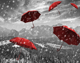 flying red umbrellas in the mountains during a storm