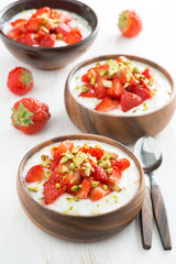 dessert of yogurt with fresh strawberries and pistachios