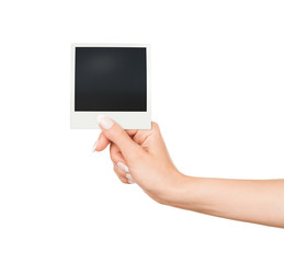 Hand holding blank Instant Photo on white background