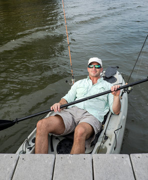 Relaxed Man Kicks Back in Fishing Kayak