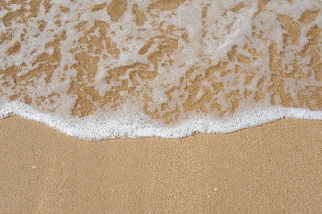 Wave of the sea on the sand beach