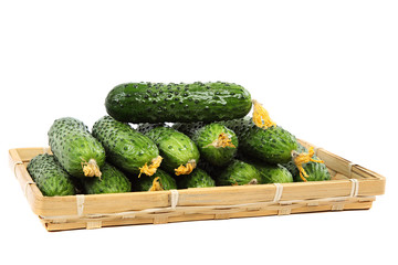 Fresh cucumbers in wooden basket.