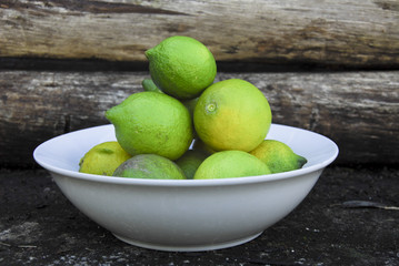 green lemons in a bowl
