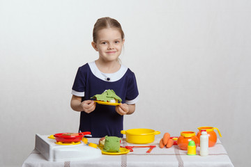 Five year old girl a plate with dish