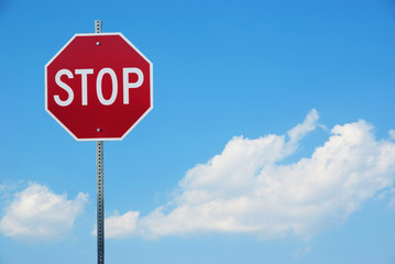 Stop sign for traffic against blue sky