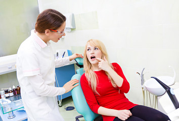 Woman patient in dentist office getting consultation from doctor