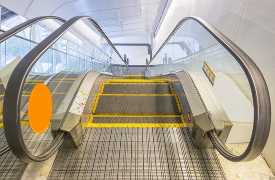 Empty Escalator Or Moving Stair. Also Called Stairway Or Staircase. Modern Architecture Design With Step, Glass For Lift People Up Floor Building I.e. Shopping Mall, Airport, Metro And Subway Station.