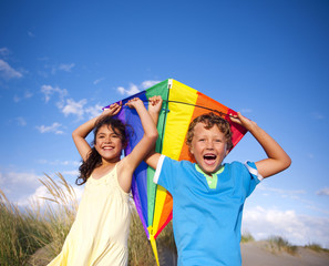 Cheerful Children Playing Kite Outdoors