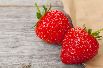 Ripe strawberries over wooden table background
