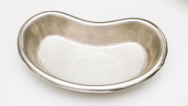 Kidney-shaped bowl, a stainless steel container, on a white back