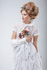 Fashion Model in Flossy White Dress and Wreath of Flowers - 66376703
