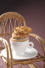 Homemade fresh cookies over coffee cup on a rocking chair