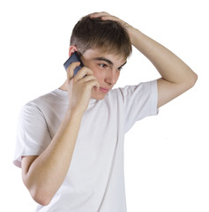 Young man portrait talking on a phone isolated on white