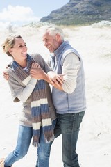 Attractive couple messing about on the beach