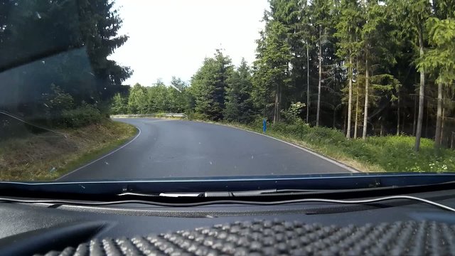 Driving the country road in the forest, shot on dash cam.