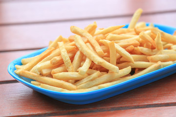 bowl of french fries on wooden table