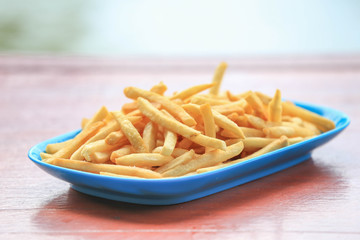 bowl of french fries on wooden table