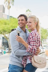 Young tourist couple pointing and looking