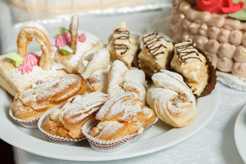 Eclairs sweets with cream sprinkled sugar powder