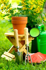 Gardening tools on green background and grass