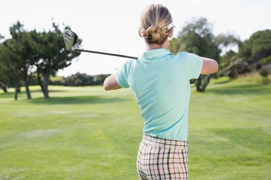 Female golfer taking a shot