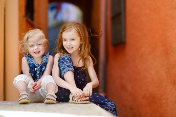 Naklejka premium Portrait of two little sisters at summer
